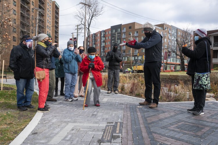 Joan Evelyn Southgate looks down at her plaque during the dedication at the Cozad Bates House.